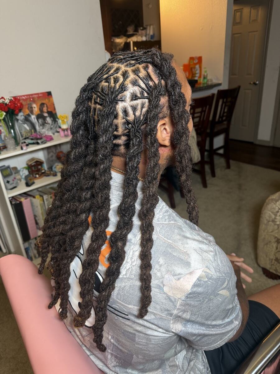 Long locs with a diamond parting pattern, side view