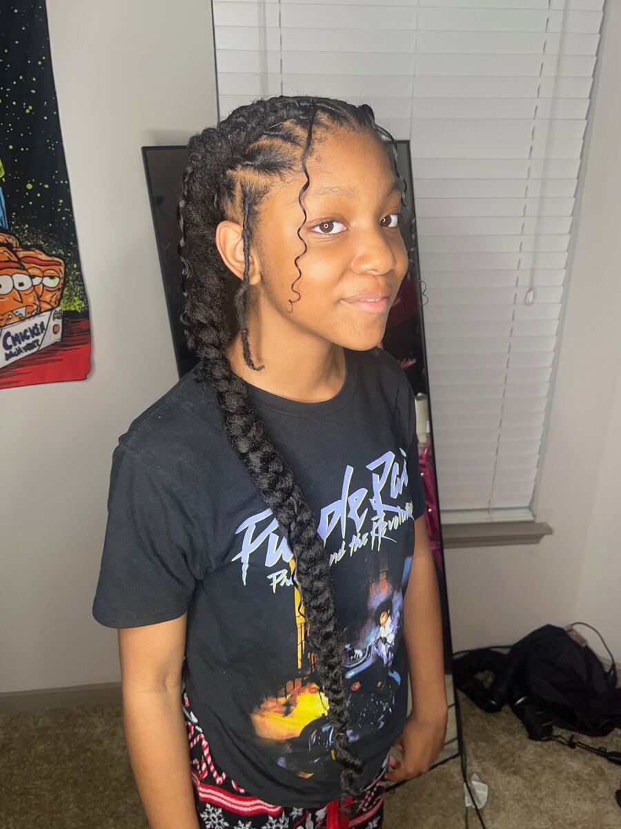 Two long feed-in braids with curled edges, side view